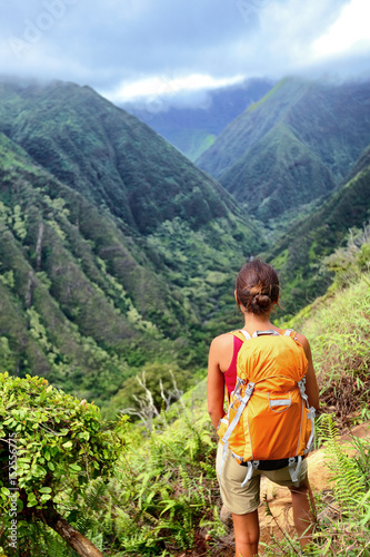 Photography Hiker woman backpacker hiking with backpack in Hawaii mountains on Waihee ridge trail, Maui, USA