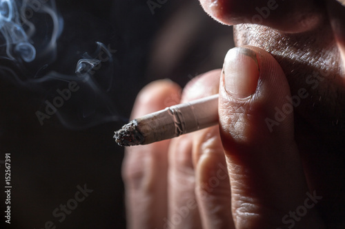 Cigarette smokes in hand