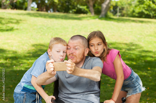 Disabled father playing with children.