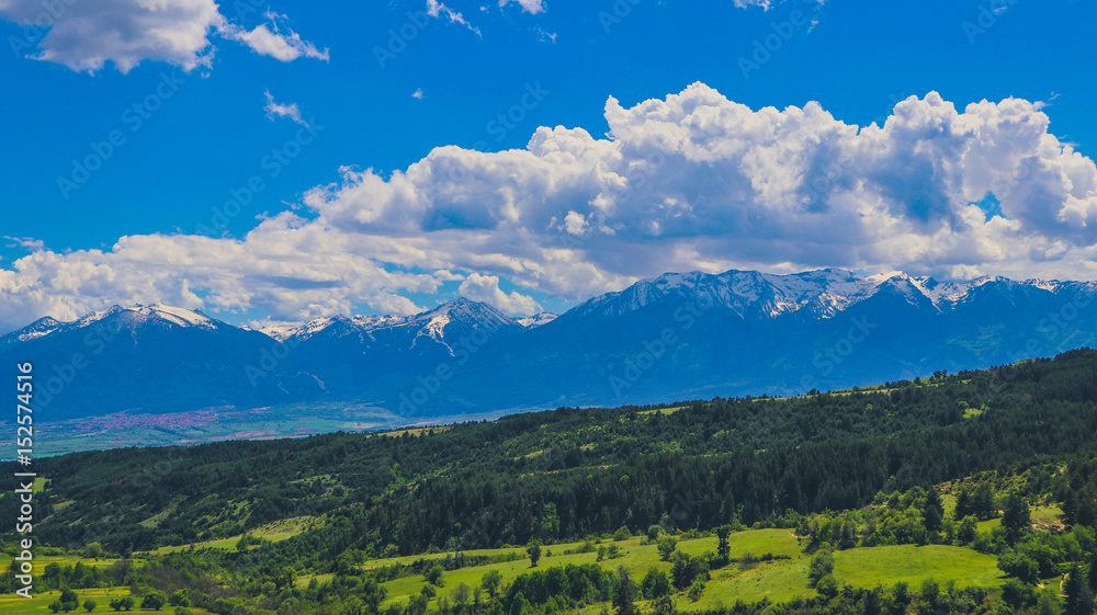 Photo depicting a beautiful colorful amazing mountain meadow paradise landscape, summertime. European alpine mountains bathed in sunshine on a blue sky background. Photo depicting a beautiful colorful amazing mountain meadow paradise landscape, summertime. European alpine mountains bathed in sunshine on a blue sky background.