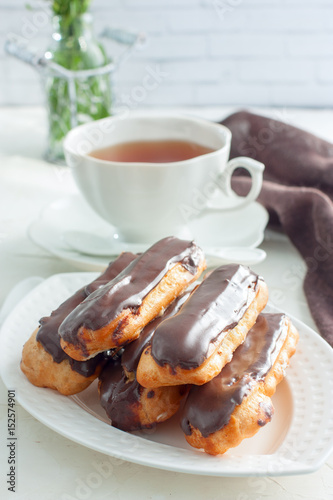 Eclairs with chocolate icing  selective focus