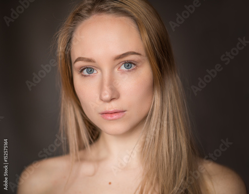 Portrait of a beautiful young woman with blue eyes.