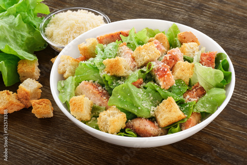 Caesar salad on a wooden background.