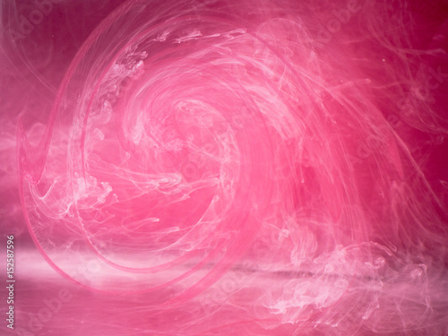 Abstract colored background. Pink smoke, ink in water, the patterns of the universe. Abstract movement, frozen multicolor flow of paint. Horizontal photo with soft focus, blurred backdrop.