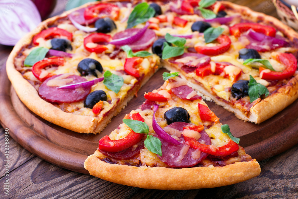 Delicious pizza served on wooden table. Italian pizza close up, top view, horizontal Delicious pizza served on wooden table. Italian pizza close up, top view, horizontal