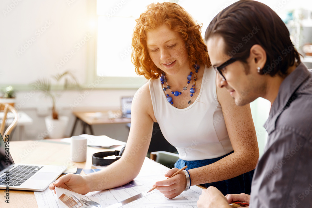 Fototapeta premium Two young architects in office