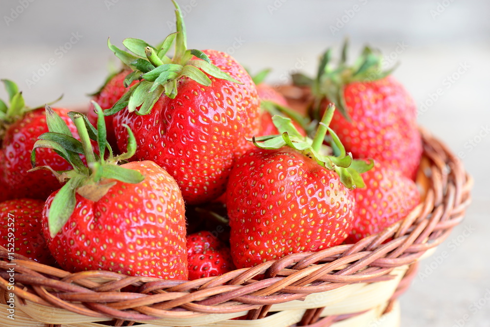 Fresh red strawberries. Sweet juicy strawberries in a wicker basket. Garden berries photo. Closeup Fresh red strawberries. Sweet juicy strawberries in a wicker basket. Garden berries photo. Closeup
