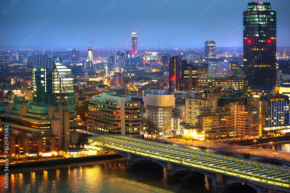 Fototapeta premium London at night, view at River Thames embankment and London bridge with night lights reflection