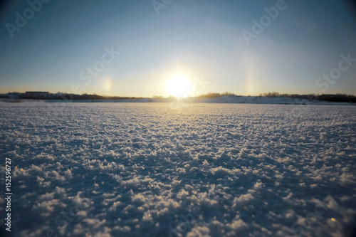 Road through the field in the snow