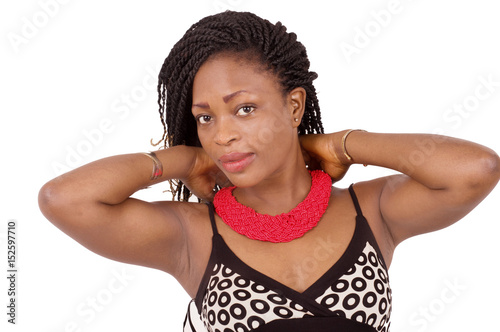 Portrait of beautiful African woman holding her neck with both hands and isolated on white background photo