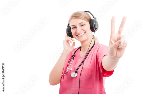 Female nurse listening to headset showing peace