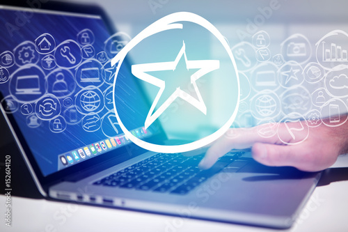 Star icon going out a laptop interface - technology concept