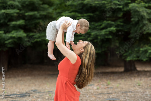 Cute Millennial mother holding todddler son photo