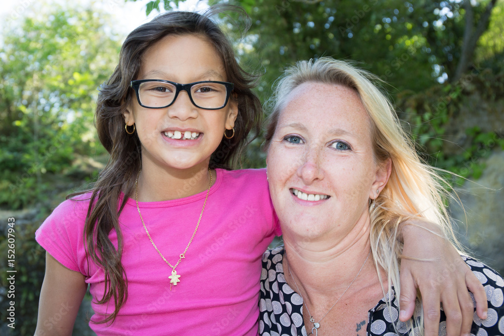 blonde mother with her brown glasses daughter in garden park blonde mother with her brown glasses daughter in garden park