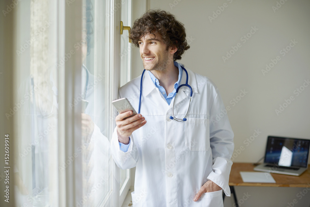 Young doctor with mobile phone Young doctor with mobile phone