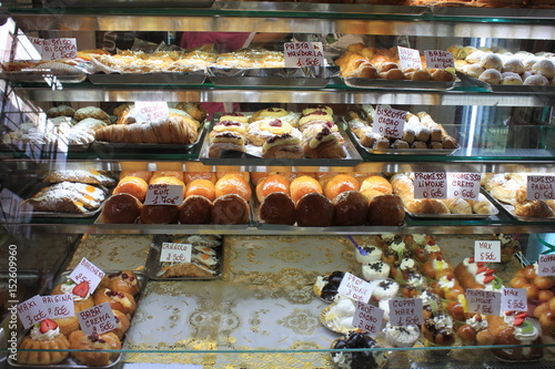 Photography Various type of cakes in shop window in Italy