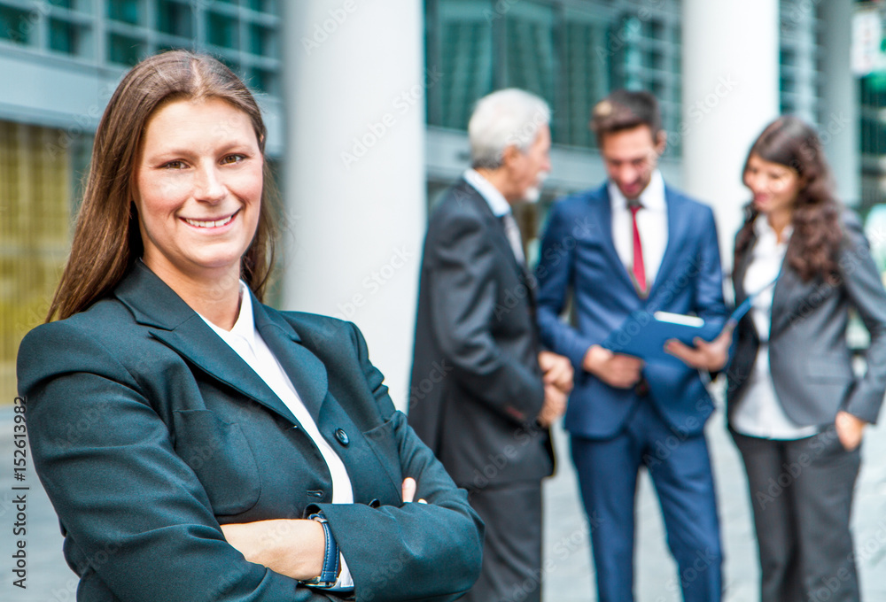 Beautiful woman on the background of business people Beautiful woman on the background of business people