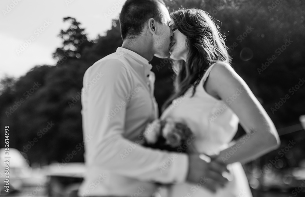 Beautiful romantic wedding couple near sea on blurred background