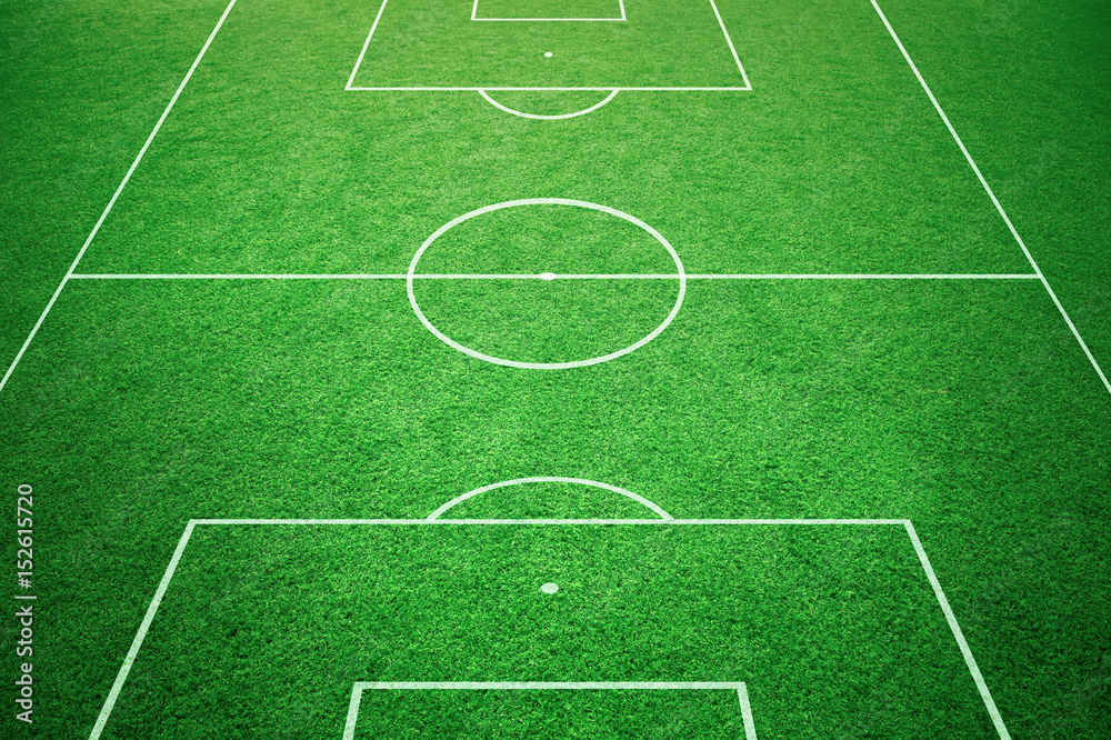 Naklejka premium Soccer playfield ground lines on sunny grass background. Goal side perspective used.