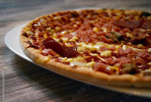 thin pizza on a wooden table