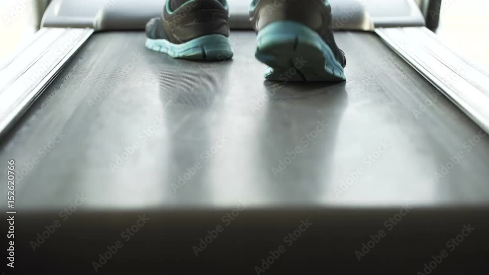 Man walking and running on treadmill in the gym, motivation and goals, sport Man walking and running on treadmill in the gym, motivation and goals, sport