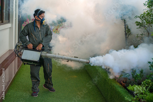 Men are working fogging to eliminate mosquito for preventing spread dengue fever