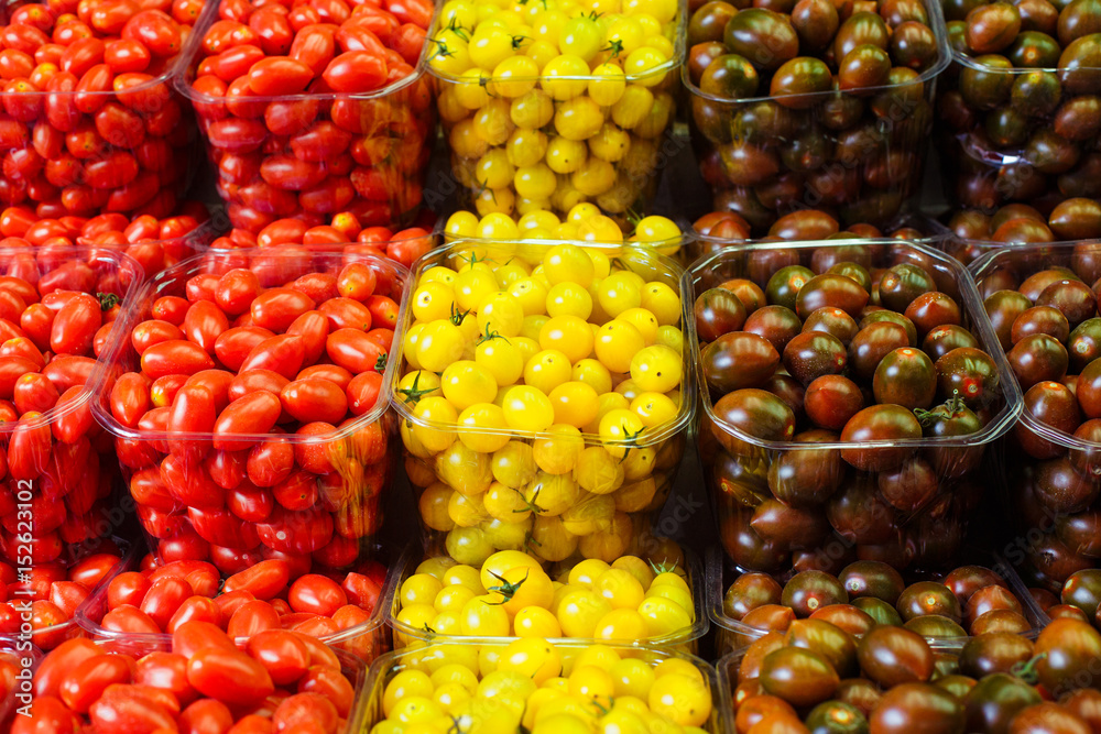 Colorful cherry tomatoes in plastic baskets