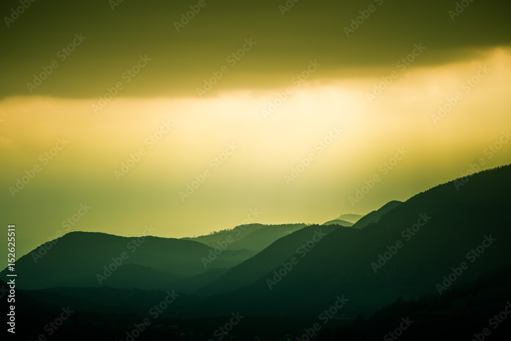Fototapeta premium A beautiful, colorful, abstract mountain landscape with a warm green summer haze. Decorative, artistic look. Mala Fatra mountains in Slovakia.