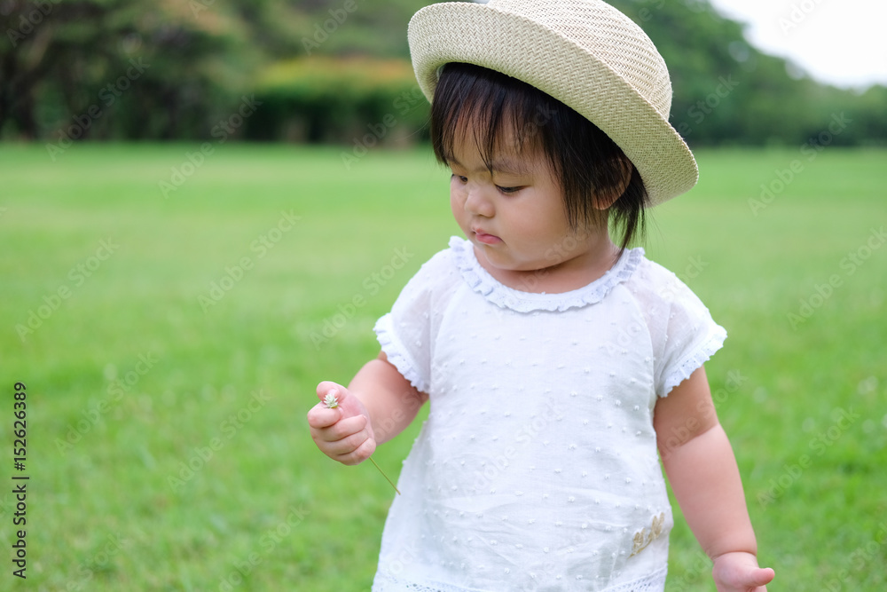 Cute Baby girl playing in the garden, close-up portrait, Portrait of Asian beautiful baby girl of 1 year and 3 months old. Cute Baby girl playing in the garden, close-up portrait, Portrait of Asian beautiful baby girl of 1 year and 3 months old.