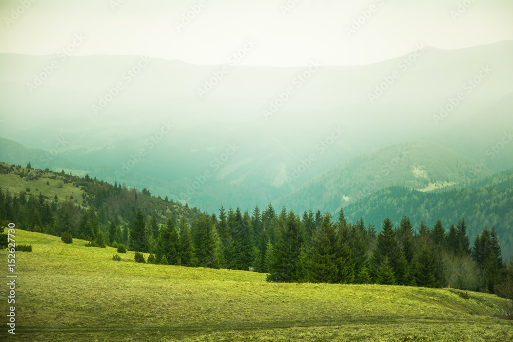 A beautiful mountain pass landscape of Tatra mountains in Slovakia. Colorful warm spring haze look.