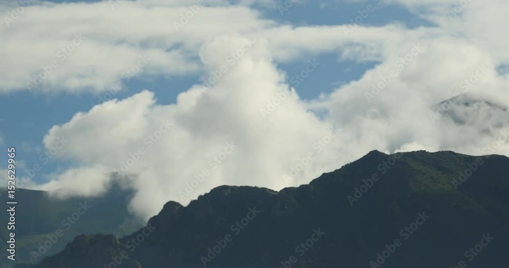 4k time lapse of white puffy clouds mass rolling over Tibet mountaintop,roof of the World. 4k time lapse of white puffy clouds mass rolling over Tibet mountaintop,roof of the World.