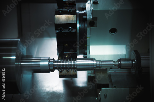 Vászonkép Operator grinding mold and die part by universal grining machine