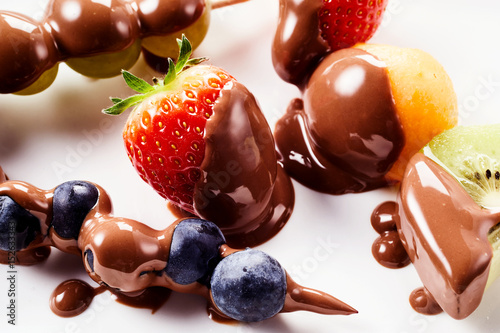 Delicious fresh fruit from a chocolate fondue photo