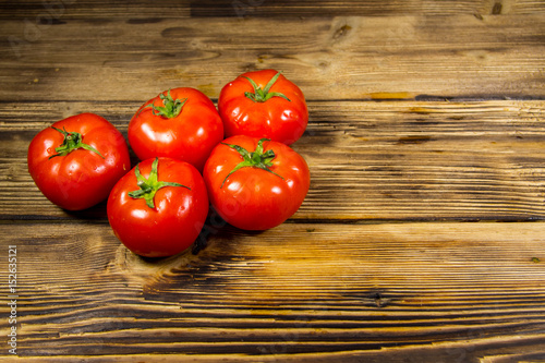 Ripe red tomatoes on wooden table