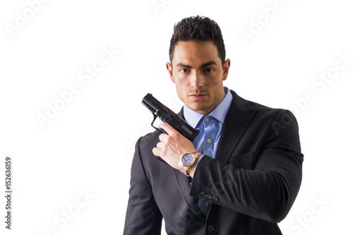Elegant man with gun, dressed as a spy or secret agent, isolated on white