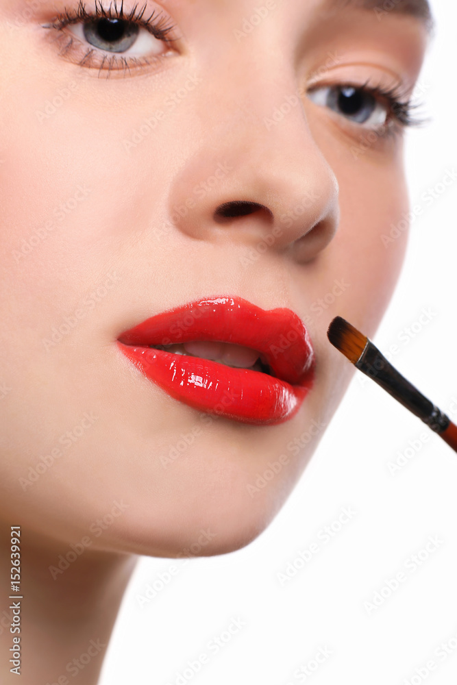 Naklejka premium Make-up artist apply lipstick with brush, beauty