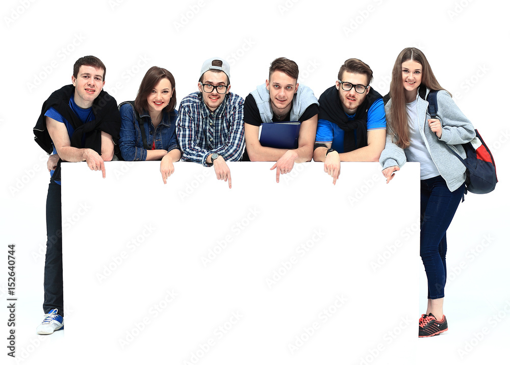 Full length portrait of confident college students displaying blank billboard against white background - obrazy, fototapety, plakaty 