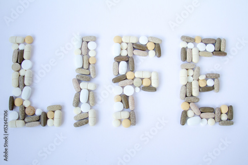 Colorful medical pills loose on a white background.