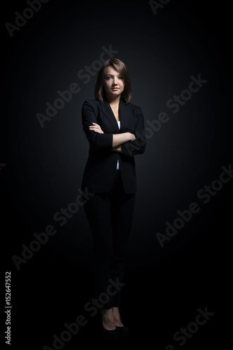 Full-length portrait of businesswoman isolated on black backgro