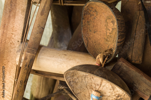 wooden wall  in old Fishing tool and old farm tools and broom