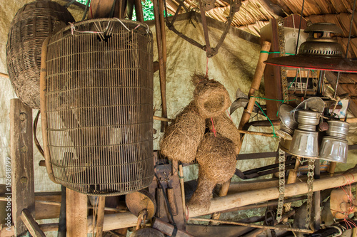 wooden wall  in old Fishing tool and old farm tools and broom