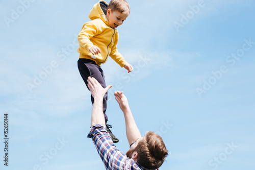 Father and his son playing together in a city park