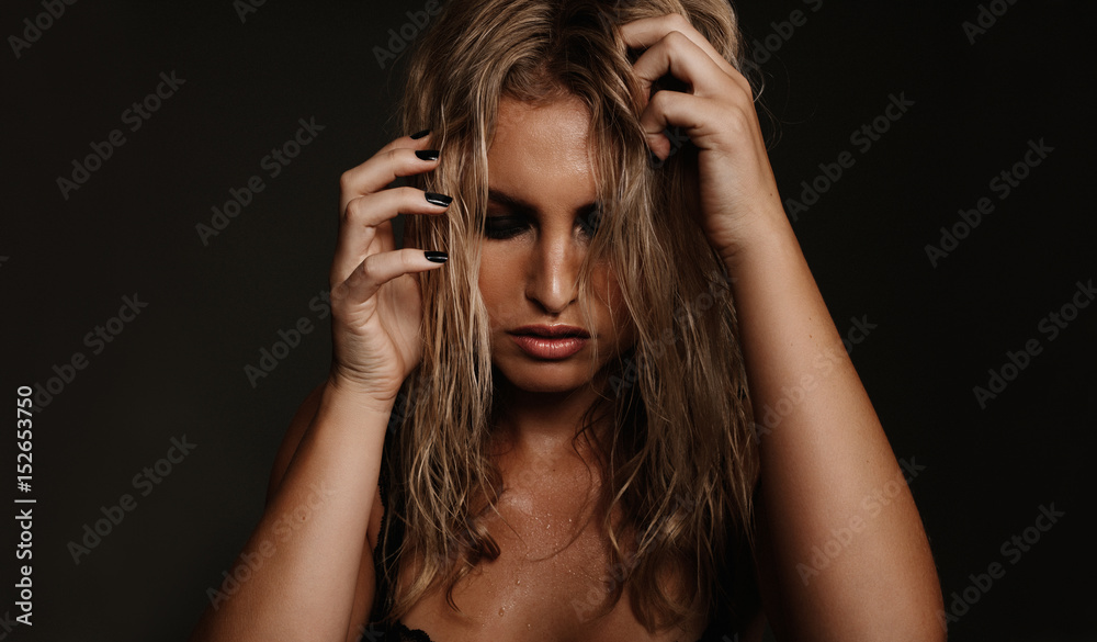 Obraz premium Beautiful young woman posing on black background