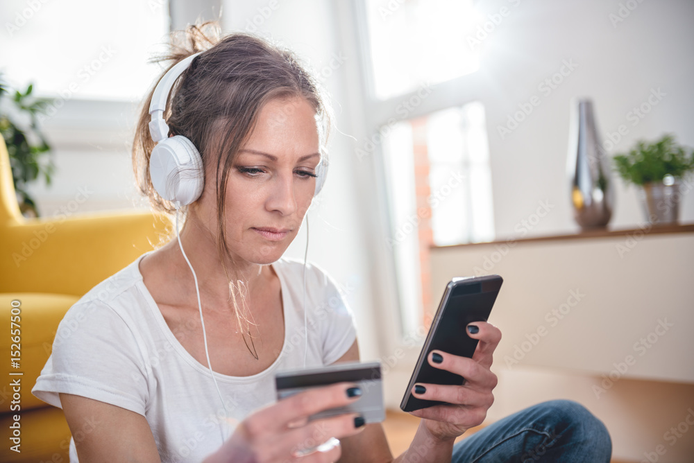 Woman shopping online and using credit card Woman shopping online and using credit card