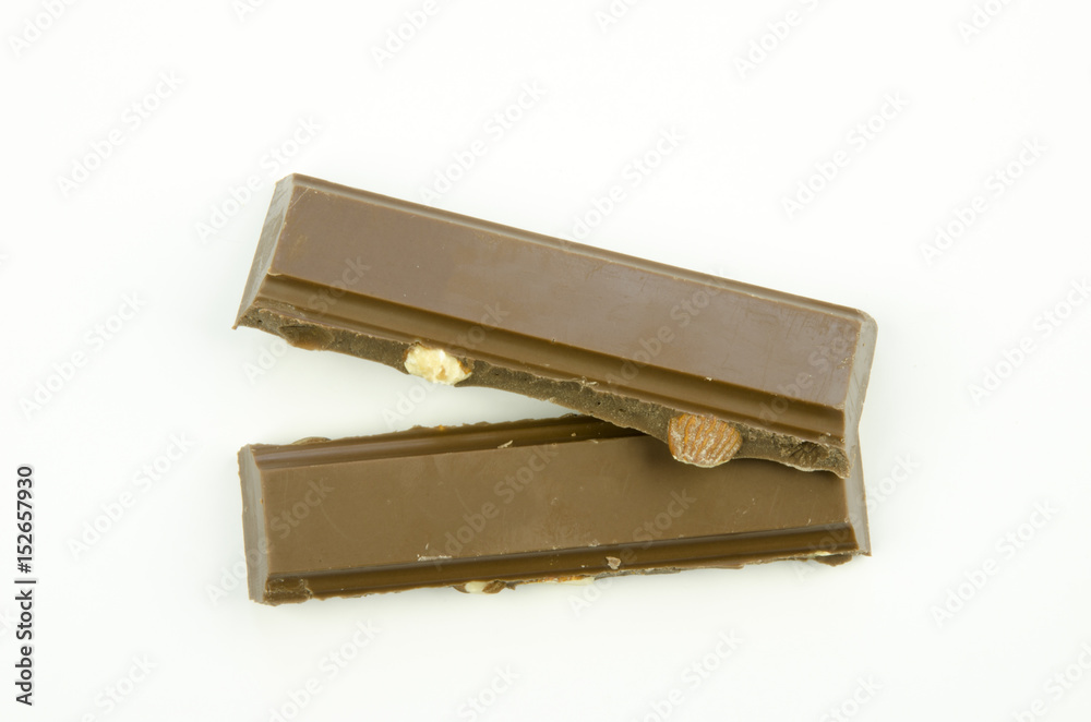 Still life with a close-up view of a broken table of milk chocolate with almonds isolated on a white background Still life with a close-up view of a broken table of milk chocolate with almonds isolated on a white background