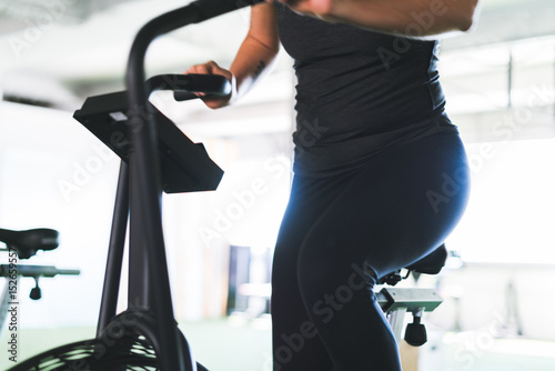 Unrecognizable woman on exerciser photo