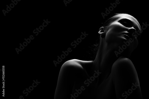 beautiful totpless woman with closed eyes on black background monochrome