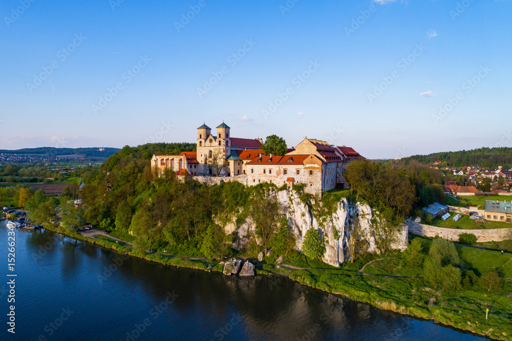 Benedictine abbey on the rocky hill in Tyniec near Cracow, Poland and Vistula River. Aerial view at sunset