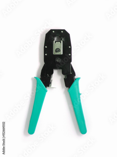 Registered Jack crimper tool, isolated on a white background. Network jumper knife colored black and green. Close up, top view.