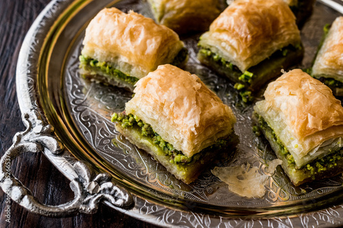Turkish Dessert Baklava with pistachio on silver tray. photo